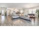 Bright, open living space with hardwood floors, modern lighting and a large comfortable sofa at 10141 Hamilton Branch Loop, Myrtle Beach, SC 29579