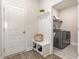 Convenient mudroom with built-in bench, coat hooks, and easy access to the laundry area at 10141 Hamilton Branch Loop, Myrtle Beach, SC 29579