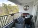 Cozy balcony furnished with stylish wicker furniture and nautical accents, overlooking a serene water view at 1024 Ray Costin Way # Villa 711, Murrells Inlet, SC 29576