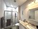 Bathroom with a shower with marble and mosaic tile, glass door, and granite vanity at 1024 Ray Costin Way # Villa 711, Murrells Inlet, SC 29576