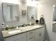 Bathroom featuring double sinks, framed mirrors, granite countertops, and white cabinetry at 1024 Ray Costin Way # Villa 711, Murrells Inlet, SC 29576