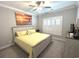 Bedroom with a queen bed, plantation shutters, a large painting and neutral decor at 1024 Ray Costin Way # Villa 711, Murrells Inlet, SC 29576