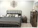 Bedroom featuring a metal bed frame, neutral colored walls and a rustic dresser at 1024 Ray Costin Way # Villa 711, Murrells Inlet, SC 29576