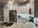 A closer view of the modern kitchen showcasing granite countertops, stainless steel appliances and bar seating at 1024 Ray Costin Way # Villa 711, Murrells Inlet, SC 29576