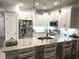 Modern kitchen features white cabinetry, granite countertops, stainless steel appliances, and a breakfast bar at 1024 Ray Costin Way # Villa 711, Murrells Inlet, SC 29576