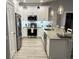 Bright kitchen with white cabinets, stainless steel appliances, granite counters, and modern pendant lighting at 1024 Ray Costin Way # Villa 711, Murrells Inlet, SC 29576