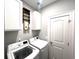 Modern laundry room with white cabinets and new washer and dryer at 1024 Ray Costin Way # Villa 711, Murrells Inlet, SC 29576