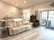 Open concept living room with vinyl flooring, a comfortable sofa, and a dining area at 1024 Ray Costin Way # Villa 711, Murrells Inlet, SC 29576