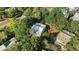 Aerial view of a charming home with a metal roof surrounded by lush trees and neighboring houses at 108 Cole Dr., Pawleys Island, SC 29585