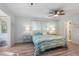 Bright bedroom with ceiling fan, wood floors, and blue, beach-themed bedding and décor at 108 Cole Dr., Pawleys Island, SC 29585