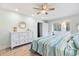 Light and airy bedroom features a ceiling fan, dresser and coastal decor at 108 Cole Dr., Pawleys Island, SC 29585