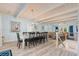 Open-concept dining room featuring a long table, white wooden beams, and light blue walls at 108 Cole Dr., Pawleys Island, SC 29585