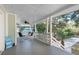 Spacious covered porch with dining set, ceiling fan, and views of the surrounding landscape at 108 Cole Dr., Pawleys Island, SC 29585