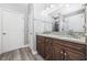 Bathroom featuring a double vanity with granite countertop, undermount sinks, and wood-style flooring at 108 Silver Peak Dr., Conway, SC 29526
