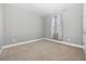 This bedroom offers neutral carpet, light walls and natural light through a window at 108 Silver Peak Dr., Conway, SC 29526