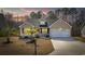 Well-lit single-Gathering home with a well-manicured lawn at twilight at 108 Silver Peak Dr., Conway, SC 29526