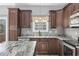 This kitchen features granite countertops, wooden cabinets and stainless appliances near a window at 108 Silver Peak Dr., Conway, SC 29526