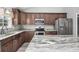 This kitchen features stainless steel appliances, granite countertops, wooden cabinets and a view of a window at 108 Silver Peak Dr., Conway, SC 29526