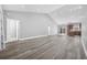 An open floor plan with hardwood floors offers kitchen view and natural light at 108 Silver Peak Dr., Conway, SC 29526