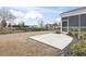 View of the backyard with a concrete patio and a screened-in porch, perfect for outdoor relaxation and entertainment at 1097 Balmore Dr., Myrtle Beach, SC 29579