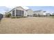 Spacious backyard with a large lawn area, patio, and play equipment, offering ample space for recreation and leisure at 1097 Balmore Dr., Myrtle Beach, SC 29579