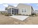 Backyard featuring a screened-in porch and a concrete patio, creating a comfortable outdoor living space at 1097 Balmore Dr., Myrtle Beach, SC 29579