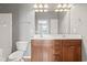 Bathroom with a double sink vanity, framed mirror, and bright lighting at 1097 Balmore Dr., Myrtle Beach, SC 29579