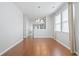 Open-concept dining room with hardwood floors, a stylish chandelier, and bright, airy windows at 1097 Balmore Dr., Myrtle Beach, SC 29579