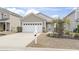 Charming home exterior featuring a well-maintained lawn, a two-car garage, and a welcoming entrance at 1097 Balmore Dr., Myrtle Beach, SC 29579