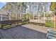 Wooden deck furnished with benches and a small table, ideal for outdoor relaxation at 11 Ryan Ln., Myrtle Beach, SC 29579