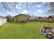Expansive backyard with well-kept lawn, fencing, and exterior of home in the background at 11 Ryan Ln., Myrtle Beach, SC 29579