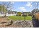 A sprawling backyard with green lawn, fencing, and an outdoor dining area for relaxation at 11 Ryan Ln., Myrtle Beach, SC 29579