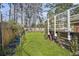 A lush backyard features a well-maintained lawn, bordered by fencing and mature trees at 11 Ryan Ln., Myrtle Beach, SC 29579