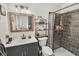 Well-lit bathroom features modern vanity, framed mirror, and tiled shower with patterned curtain at 11 Ryan Ln., Myrtle Beach, SC 29579