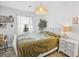 Cozy bedroom with decorative plants, neutral-toned bedspread and woven pendant lighting at 11 Ryan Ln., Myrtle Beach, SC 29579