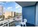 Balcony view overlooking resort area with a white plastic chair and a view of another resort at 1105 S Ocean Blvd. # 446, Myrtle Beach, SC 29577