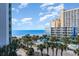 Scenic view of a beach with palm trees and buildings under a clear sky, creating an inviting coastal atmosphere at 1105 S Ocean Blvd. # 446, Myrtle Beach, SC 29577