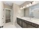 Bathroom featuring a double vanity, large mirror, and shower at 1110 N Middleton Dr. Nw, Calabash, NC 28467