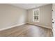 Bright bedroom features hardwood floors and a window overlooking a wooded area at 1110 N Middleton Dr. Nw, Calabash, NC 28467