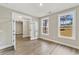 Bright bedroom featuring luxury vinyl flooring, a glass paneled door, and large windows with ample natural light at 1110 N Middleton Dr. Nw, Calabash, NC 28467