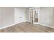 Bedroom featuring luxury vinyl flooring, a double-door closet, and glass paneled door at 1110 N Middleton Dr. Nw, Calabash, NC 28467