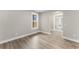 Bright, empty bedroom featuring stylish wood-look floors and light-colored walls with white trim at 1110 N Middleton Dr. Nw, Calabash, NC 28467