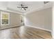 Spacious bedroom featuring tray ceiling, ceiling fan, and large windows at 1110 N Middleton Dr. Nw, Calabash, NC 28467