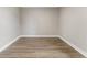 Clean, empty bedroom with modern wood-look floors and neutral-colored walls, ready for personalization at 1110 N Middleton Dr. Nw, Calabash, NC 28467