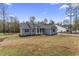 Attractive single-story home with a gray exterior, complemented by a spacious lawn and surrounding trees at 1110 N Middleton Dr. Nw, Calabash, NC 28467