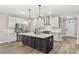 Well-equipped kitchen boasts stainless appliances, an island with seating, and stylish pendant lighting at 1110 N Middleton Dr. Nw, Calabash, NC 28467