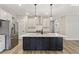 Modern kitchen features a large island, stainless steel appliances, and ample cabinet space at 1110 N Middleton Dr. Nw, Calabash, NC 28467