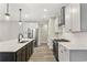 Modern kitchen with stainless steel appliances, an island, and ample cabinet space and natural light at 1110 N Middleton Dr. Nw, Calabash, NC 28467
