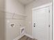 Convenient laundry room featuring a wire rack shelf and a bright white door at 1110 N Middleton Dr. Nw, Calabash, NC 28467