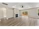 An airy living room featuring a fireplace, access to a deck, and recessed lighting at 1110 N Middleton Dr. Nw, Calabash, NC 28467